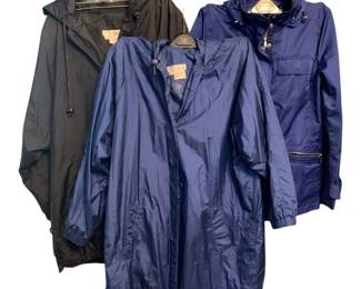 2120 - 2 Norm Thompson Rain Jackets & 1 Talbot M (Description): A collection of three rain jackets featuring  two Norm Thompson rain jackets and one Talbot  hooded jacket in size medium. The lot  includes both navy blue and black outerwear  options suitable for inclement weather.