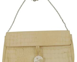 1846 - Vintage Tanner Handbag 5"x9"x2" (Description): Vintage Tanner handbag featuring a  crocodile-embossed leather exterior in a  cream color. The bag is accented with a  mother of pearl button closure and a  silver-tone chain strap. Measures 5 inches high by 9 inches wide by 2 inches deep.