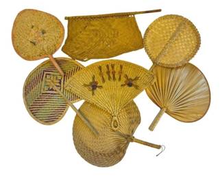 1444 - Collection of 8 Vtg Woven Hand Fans (Description): A collection of eight vintage woven hand fans  in various styles and patterns. The  assortment includes fans crafted from natural  materials including straw, rattan, and palm  leaf. Several feature decorative woven geometric patterns in natural earth tones,  while others display more elaborate designs  with colored accents. The fans showcase  different construction techniques including  herringbone weave, diagonal patterns, and