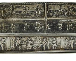 90 - Barbour Silver Co Silver Plate Tray 2"x9"x6" (Description): A silver plate tray by Barbour Silver Co  featuring detailed repousse decoration  depicting figures in various domestic and  tavern scenes. The rectangular tray has  rounded corners, twin scrolled handles, and rests on four ball feet. The interior is divi