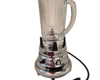 3975 - Waring Chrome and Glass Commercial Blender (Description): Commercial blender featuring a chrome base  with control buttons and a clear ribbed glass  pitcher with handle. The unit has a classic  mid-century design with a sturdy construction  suitable for commercial use. Used as is electric/electronic/mechanical  item. No guarantee all components, untested.