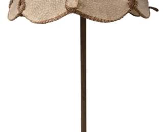 4125 - Vintage Brass Floor Lamp w/ Scalloped Shade (Description): Vintage brass floor lamp featuring a  bell-shaped scalloped shade with decorative  rosette accents and fringe trim. The lamp has  a slender pole design with a turned detail  and sits on a round stepped base with an aged patina finish. The shade displays a textured  cream-colored fabric. Measures 63" tall.  Shows age appropriate wear. Used as is electric/electronic/mechanical  item. No guarantee all components, untested.