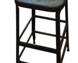 3992 - Metal Bar Stool 30"x14"x14" (Description): Industrial metal bar stool with square seat  featuring ventilation holes. The stool has a  sturdy four-legged base with cross bracing  for stability and shows a weathered gray  patina. Measures 30 inches in height with a 14 by 14 inch seat.