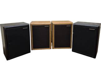 3996 - 4 American Acoustics Speakers (Description): A collection of four American Acoustics  speakers. The set includes two larger  speakers in black wood grain cabinets and two  smaller speakers in natural oak finish  cabinets. All speakers feature black fabric grilles with the American Acoustics nameplate  on the front. Used as is electric/electronic/mechanical  item. No guarantee all components, untested.