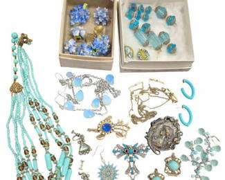 2703 - Group Vtg Blue & Turquoise Costume Jewelry (Description): A group of vintage costume jewelry in  coordinating shades of blue and turquoise.  The collection includes various earrings,  brooches, necklaces, pins, and pendants  featuring glass beads, faux turquoise stones, and decorative metalwork. Notable pieces  include a multi-strand beaded necklace with  turquoise and amber-toned beads, floral and  butterfly motif brooches, a cross pendant,  and several pairs of clip-on and pierced