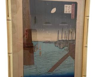 1187 - Japanese Woodblock in Oriental Frame 13"x17" (Description): Oriental frame measuring 13 inches by 17  inches. The frame features a bamboo-style  design and contains a Japanese woodblock  print depicting a harbor scene with boats and  a crescent moon.