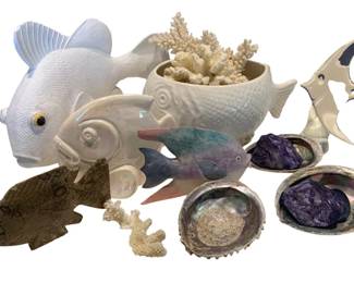 1329 - Group Lot of Fish Decor (Description): Group lot of fish decor featuring various  decorative fish figures and nautical themed  pieces. The lot includes ceramic, carved, and  decorative fish in assorted styles and  materials, along with coral specimens and abalone shells.