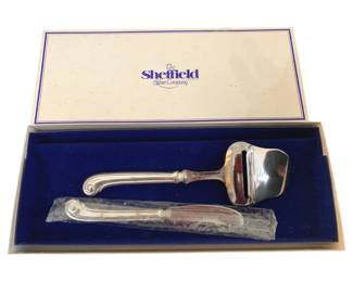 377 - Sheffield Cheese Server 10" (Description): Sheffield Silver Company cheese server  presented in original box with blue velvet  lining. The server features an elegant  handled design. Measures 10 inches in length.