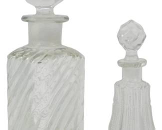 892 - 2 Vintage Glass Perfume Bottles 7.5" (Description): Two vintage glass perfume vials with faceted  stoppers. The larger vial features a swirl  pattern design while the smaller vial has a  ribbed vertical pattern. The larger vial  measures 7.5 inches tall.