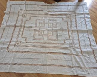 1309 - Vtg White Linen Tablecloth w/ Cutwork 64x72" (Description): Vintage white linen tablecloth featuring  intricate cutwork and drawn thread  embroidery. The design showcases a geometric  central medallion with radiating openwork  borders and delicate floral motifs throughout. The tablecloth displays  traditional European needlework techniques  with multiple concentric decorative bands.  Measures 65" x 67".
