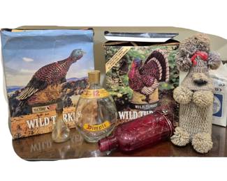 3971 - Group of Bar Items (Description): Group of bar itams including two Wild Turkey  bourbon boxes with turkey imagery, a Dimple  Pinch 12 Year Scotch whisky bottle, a small  clear glass oil lamp, a cranberry glass  decorative bottle, and a handmade yarn crocheted dog figurine with red ribbon  accent.