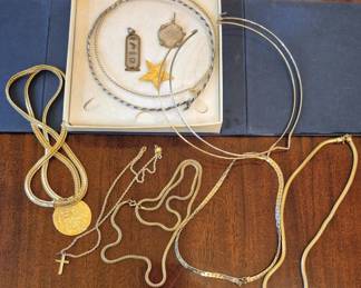 1490 - Mixed Necklace & Pendant Lot (Description): Assorted group of necklaces, chains, and  pendants including a medallion, cross  pendant, and several gold-tone and  silver-tone pieces. Includes boxed items and  loose chains in a variety of styles.