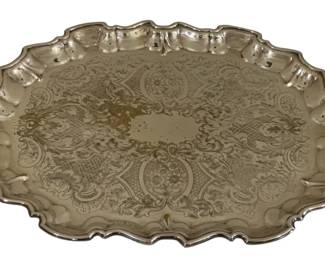 587 - Silver Plate Footed Tray 26"x17" (Description): Featuring an ornate engraved design with  scrollwork and floral motifs. The tray has a  scalloped edge and decorative handles on each  side. Measures 26 inches by 17 inches.