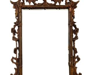 1336 - Rococo Style Wood Carved Mirror (Description): Antique Rococo style mirror frame with  elaborate carved scrollwork and acanthus leaf  details. The frame features an ornate  pierced crest with scrolling foliate motifs  and decorative openwork along the sides. Finished in a warm gilt bronze tone over  wood. Measures 54 inches by 33 inches.