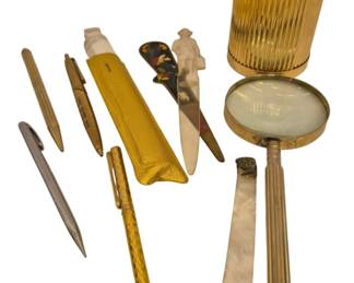 2741 - Vtg Desk Accessories Pens Letter Openers Lot (Description): A collection of vintage desk accessories  including pens, letter openers, and related  items. The lot features a gold-toned ribbed  cylindrical container, a brass magnifying  glass, several mechanical pencils and pens including a yellow guilloche-stylepen,  assorted letter openers including one with a  figural handle and one with  tortoiseshell-style decoration, and a mother  of pearl handled page turner or letter