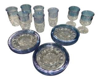 954 - 20 Pc Tiffin King's Crown Blue Glassware (Description): A 20-piece collection of blue iridescent  pressed glassware featuring coordinating  plates and drinking vessels. The set includes  decorative plates with scalloped edges and  sunburst patterns, tall tumblers, and footed goblets.