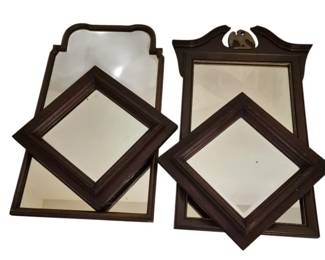 3917 - 4 Mahogany Framed Mirrors (Description): A group of four wall mirrors featuring dark  wood frames in various styles. The collection  includes two rectangular mirrors with shaped  crests, one topped with a brass eagle finial  in Federal style, and two diamond-shaped mirrors with beveled edges.