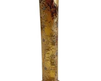 386 - Moser Art Glass 8" Bud Vase w/ Gold Overlay (Description): Elegant amber glass bud vase featuring ornate  silver and gold overlay decoration. The  cylindrical form showcases intricate floral  and scrollwork patterns throughout, with a  scalloped rim and faceted pedestal base. The rich amber glass provides a warm backdrop for  the detailed metallic embellishments.  Measures 8 inches tall.
