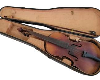 443 - Antonius Stradiuarius Violin w/ Case (Description): Vintage violin with case stamped Antonius  Stradiuarius. The violin case features a dark  brown or black exterior with metal hardware  and a carry handle, showing age-appropriate  wear. Case measures 24 x 7 inches; violin case measures 30 x 9 inches.