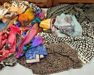 2851 - Lot of Assorted Animal Print Scarves (Description): A collection of assorted animal print scarves  featuring a variety of patterns including  leopard, zebra, giraffe, and cheetah prints.  The lot includes scarves in various colors  and materials, from sheer chiffon to silk-like fabrics, in both bold and muted  color palettes. Patterns range from classic  safari-inspired animal prints to abstract  interpretations in vibrant hues of pink,  purple, orange, blue, and earth tones.