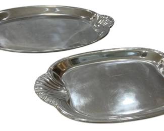 929 - 2 Shell Handle Pewter Serving Trays (Description): Pewter serving trays featuring decorative  shell-form handles at each end. Elegant oval  shape with gently curved edges and a polished  finish. Measures 16.5" x 10.5".