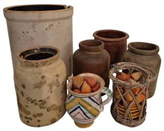3923 - Group Lot of Crocks & Pottery Vessels (Description): A group lot of crocks and assorted pottery  vessels including stoneware crocks in various  sizes, earthenware jars, a decorative  pitcher with colorful chevron pattern, and a  wicker basket. The collection features both glazed and unglazed pieces in cream, brown,  and terracotta tones. Some vessels contain  wooden items.