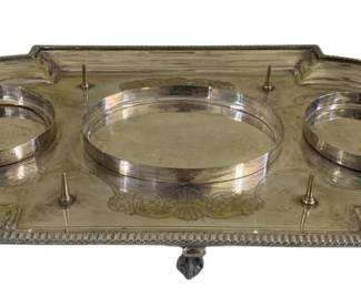 1678 - Silver Plate Footed Tray w/ Handles (Description): Featuring ornate handles and three circular  recessed areas. The tray has decorative  engraved details and a gadroon edge. Measures  4 inches in height at the handles by 19  inches long by 11 inches wide.