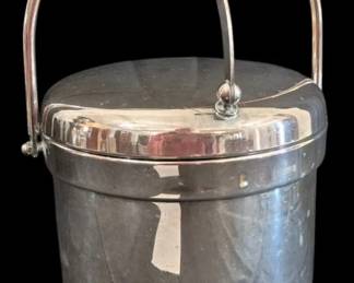 519 - Rogers Silver Plated Ice Bucket w/ Lid 14" (Description): Rogers silver plate ice bucket with lid,  measuring 14 inches tall. This elegant piece  features a swing handle with decorative  finial attachments, a fitted domed lid with  matching finial, and stands on four ornate claw feet. The bucket has a classic round  form with clean lines typical of mid-century  barware design. Complete with removable  insulated liner for keeping ice cold during  entertaining.