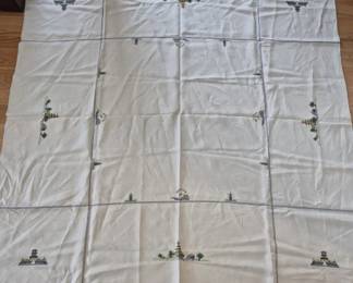 1308 - Oriental Embroidered Tablecloth & Napkins 69"x80" (Description): Oriental tablecloth set featuring delicate  cross-stitch embroidery depicting pagodas and  Asian-inspired landscape motifs. The  cream-colored linen cloth is accented with  hemstitched borders creating a grid pattern with embroidered designs at regular intervals  throughout. Measures 69" x 80".