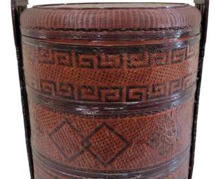 459 - Large Chinese Wedding Basket 24"x17" (Description): Large Chinese wedding basket featuring a  traditional stacked design with three woven  tiers. The basket is crafted from finely  woven rattan or bamboo with a rich  reddish-brown lacquered finish. Each tier displays intricate geometric patterns  including Greek key motifs and diamond  designs in darker contrasting weave. The  basket features a sturdy fixed handle with  brass fittings at the top for carrying.