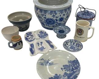 991 - Assorted Blue & White Ceramics Collection (Description): An assorted collection of blue and white  ceramics featuring a variety of decorative  and functional pieces. The lot includes a  large Chinese-style fishbowl planter with  floral motifs, a stoneware crock with blue banding, a spongeware canister with wire bail  handle, a transferware plate depicting a  landscape scene with crane, a spoon rest with  willow pattern decoration, a small pedestal  dish, a miniature blue and white mug, a small