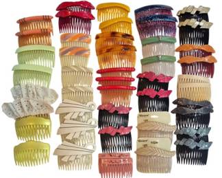1986 - Group Vtg Decorative Hair Combs (Description): A collection of vintage hair combs in various  colors, styles, and materials. The group  includes side combs with decorative tops  featuring bows, geometric shapes, and  textured designs. Colors range from natural tortoiseshell tones to vibrant reds, yellows,  greens, and neutrals. Some combs retain  original retail cards. An assortment suitable  for collecting or everyday use.