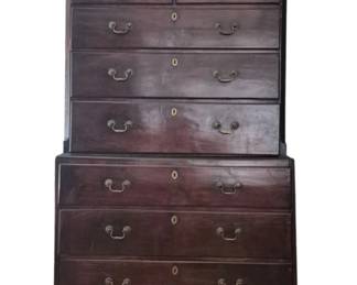 2046 - English 2 Part High Chest w/ Keys 70"x42"x20" (Description): English two-part high chest with keys. This  Georgian-style chest-on-chest features a rich  mahogany finish with dentil molding along  the cornice. The upper section contains two  small drawers over four graduated long drawers, while the lower section houses three  additional long drawers. Each drawer is  fitted with brass bail handles and  escutcheons. The piece rests on bracket feet.
