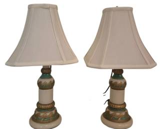 3789 - Pr Vtg Case Glass Table Lamps w/ Shades 19" (Description): Pair of vintage case glass table lamps with  cream-colored bases featuring decorative teal  and gold painted wave motifs. The  baluster-form bases display gilded accents  and layered decorative bands. Each lamp is topped with a coordinating cream bell-shaped  fabric shade. Used as is electric/electronic/mechanical  item. No guarantee all components, untested.