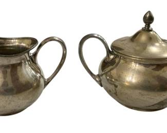 2758 - Sheffield Reproduction Creamer & Sugar (Description): Sheffield reproduction creamer and covered  sugar set. The set includes a creamer with a  graceful spout and handle, along with a  lidded sugar bowl featuring two handles and a  decorative finial on the lid. Both pieces display a classic silver-plated finish in the  traditional Sheffield style.