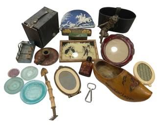 999 - Vtg Collectibles Group w/ Camera & Decor (Description): This eclectic assortment includes a black box  camera case, blue and white jasperware-style  hunting scene plaque, decorative silhouette  tray featuring harlequin figures, Dutch  wooden clog marked "Heineken's Lager," figural cherub holder, assorted glass  coasters and small dishes in aqua and  amethyst tones, small oval picture frame,  amber glass bottle, bottle opener, red  lacquer frame, wooden garden tool, and