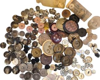 1463 - Asst Vtg Buttons in Various Materials (Description): Assorted vintage buttons in a variety of  materials, colors, and styles. The collection  includes mother of pearl, horn, metal  crown-shaped buttons, fabric-covered buttons,  rhinestone cluster buttons, and various plastic and Bakelite examples. Colors range  from cream and pink to brown, black, and  metallic tones. Some buttons are stored in  small glass and plastic containers. Sizes  vary from small shirt buttons to large coat