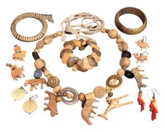 1972 - Collection of Carved Wooden Jewelry (Description): A collection of carved wooden jewelry  featuring a variety of animal-themed and  geometric designs. The assortment includes a  carved tiger bangle bracelet with striped  pattern, a chunky geometric wooden bead necklace with various shaped beads in natural  wood tones, a matching bracelet, and a solid  wooden bangle. Also included are multiple  pairs of earrings featuring carved animal  figures including elephants, camels, horses,
