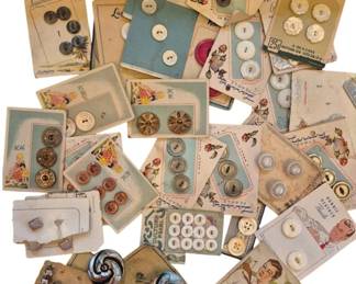 1459 - Assorted Vtg Buttons on Original Cards (Description): A collection of assorted vintage buttons on  their original display cards. The lot  includes a variety of styles featuring mother  of pearl buttons, metal buttons, plastic  buttons, and decorative buttons in various sizes and colors. Many cards feature charming  period graphics and brand names including  Premier Quality, Lucky Day Pearls, La Chic  Mother of Pearl, and others. Cards display  typical mid-century designs with floral