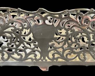 532 - Reticulated Quadruple Plate Ferner (Description): Featuring an elaborate scrollwork design  throughout the body. The decorative cachepot  rests on small footed supports and displays  an ornate openwork pattern with foliate  motifs. Sold as-is with noted damage. Measures 14 inches by 7 inches.