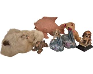 3785 - Lot of Assorted Animal Figurines & Decor (Description): Lot of assorted decorative items featuring  animal motifs. The collection includes a  fluffy fur cat figure, a terracotta fish  sculpture, ceramic and resin dog figurines, a  small copper-toned bear figure, a pair of blue floral bookends with bird designs, and a  plush dog toy with pink ribbon. Various  materials including ceramic, resin, metal,  and plush fabric.