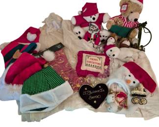 4078 - Group of Christmas Items (Description): A festive collection of Christmas items  including plush holiday teddy bears and  snowmen in red and white attire, Santa hats  in various colors including red and green, a  cross-stitch 'Merry Christmas' pillow, a heart-shaped 'I Believe In Santa' decoration,  clear glass ornament balls, a beaded Santa  figurine, a cream-colored table runner or  fabric, Christmas stockings with polka dot  and fur trim details, and various holiday
