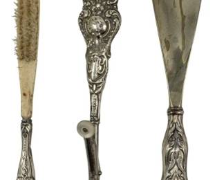 736 - 3 Various Items Marked Sterling 4.22oz (Description): A collection of three various items marked  sterling, including vanity and grooming  accessories with ornate handles. Total weight  4.22 ounces.