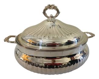 375 - Silver Plate Covered Casserole Dish 7"x11" (Description): Silver plated covered casserole dish  featuring an elegant domed lid with ornate  scroll finial and decorative twin handles.  The body displays attractive fluted detailing  along the lower portion. Measures 7 inches by 11 inches.
