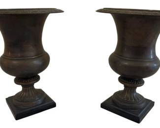 547 - Pr Metal Urns Made in Korea 10"x9" (Description): Pair of classical style metal urns made in  Korea. These campana-form urns feature flared  rims with Greek key decorative banding,  baluster-shaped bodies, and gadrooned socle  bases resting on square plinths. The urns display a rich bronze-toned patina finish.  Each measures 10 inches by 9 inches.