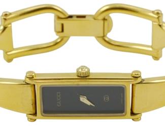 1915 - Gucci 1500L Gold Plated SS Ladies' Watch (Description): Gucci 1500L ladies' watch featuring a gold  plated stainless steel case and bracelet. The  watch is currently not running. Used as is electric/electronic/mechanical  item. No guarantee all components, untested.