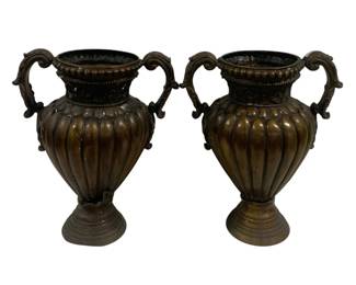 8001 - Pair Bronze Handled Urns 21.5"x17.5" (Description): A pair of bronze urns featuring classical  amphora-style forms with elegant double  scroll handles. Each urn displays a ribbed  gadrooned body with decorative beaded  detailing around the rim and ornate acanthus leaf motifs on the handles. The urns reston  reeded circular pedestal bases and exhibit a  rich patinated bronze finish. Measures 21.5"  x 17.5".