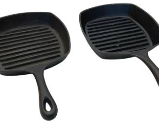 914 - 2 Enamel Cast Iron Grill Pans 16.5"x1"x2" (Description): Pair of enamel cast iron grill pans featuring  ridged cooking surfaces ideal for grilling  and searing. Each pan has a squared shape  with rounded corners and a sturdy handle with  a hanging loop at the end. The pans are finished in a classic black enamel coating.  Measures 16 1/2" x 1" x 2".
