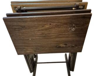 3950 - Set of Folding TV Trays with Stand (Description): A set of folding TV trays with a storage  stand. The trays feature a dark wood grain  finish and fold flat for convenient storage.  The set includes multiple trays that nest  together on the accompanying stand with folding legs.