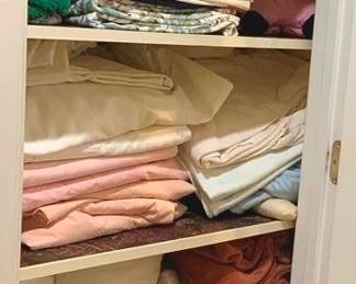 1198 - Closet Lot of Assorted Linens & Textiles (Description): A closet lot containing an assortment of  household linens and textiles including  sheets, blankets, towels, and various fabric  items in assorted colors and patterns.